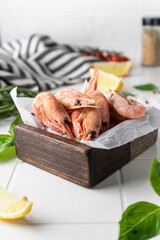 Thawed peeled shrimp, seafood, delicacy. on a white background, in a dish. beautiful product...