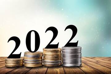 Coins and Figures 2022. Money stacked in columns.