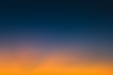 Abstract gradient sunrise in the sky with blue and orange natural background.