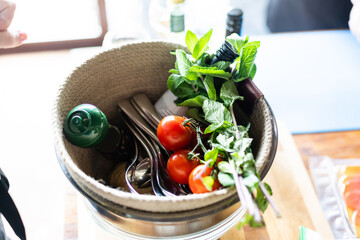 Cherry tomatoes with basil on wooden table close up