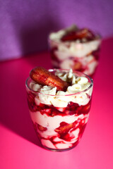 Colorful and creamy - delicious fruit and berries tiramisu cake in glass