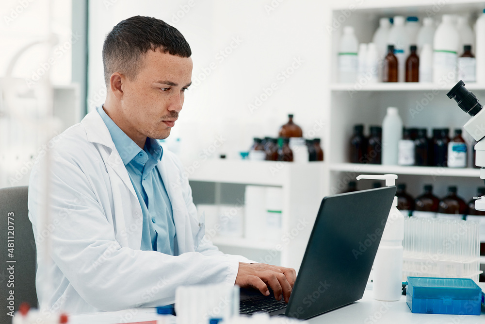 Poster Keep calm, the cure is coming. Shot of a young scientist using a laptop while working in a laboratory.