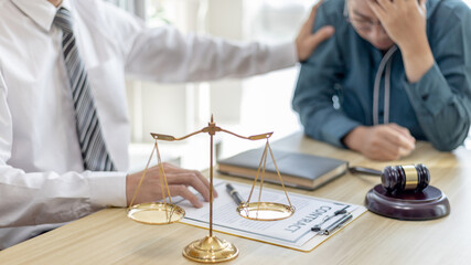 Prosecutor or lawyer comforts a client who is worried about a fraudulent business, Legal and Justice Litigation Assistance, legal consultant, scales of justice, law hammer, Litigation and justice.