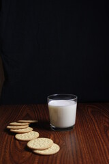 milk with cookies on a dark background