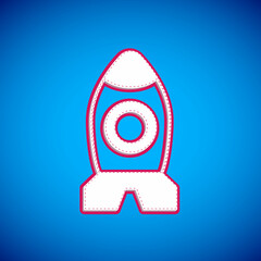White Rocket ship toy icon isolated on blue background. Space travel. Vector
