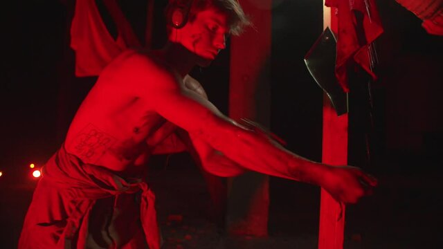 A young guy with a naked torso washes his hands in a performance about communism. Purification concept
