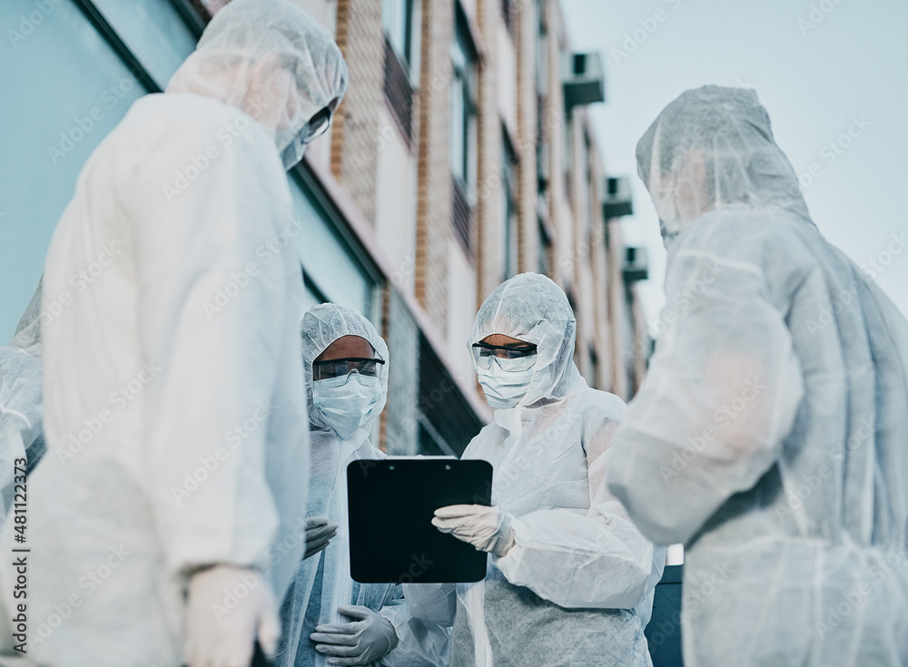 Poster teamwork makes infection control work. shot of a group of healthcare workers wearing hazmat suits wo