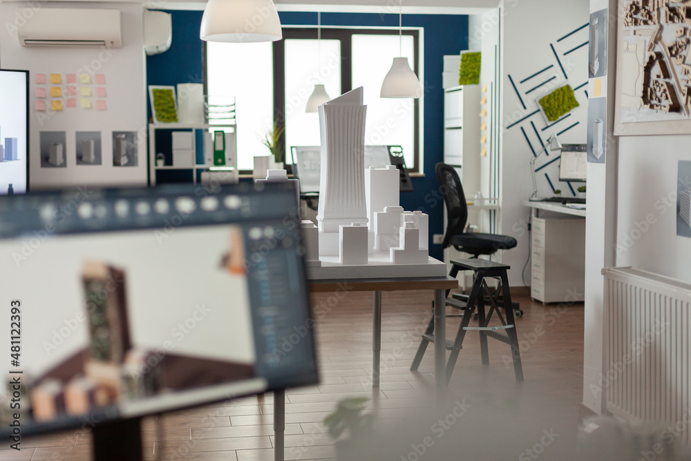 Poster table with scale foam model of skyscraper in empty architectural office used for urban development a