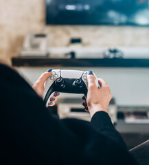 Woman's Hands holding a wireless gamepad. Concept games, video games © VlaDee