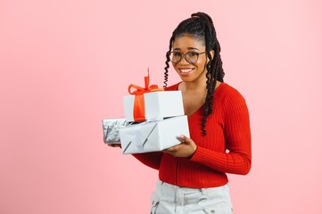 Photo of cheerful positive girl hold gift package isolated pink color background.