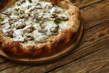 Appetizing pizza with mushrooms on a wooden tray