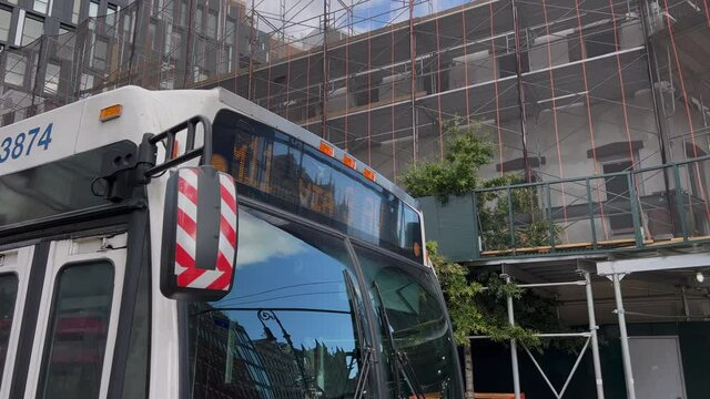 Public transport in the city. Regular bus in New York, USA. The bus is at stop.