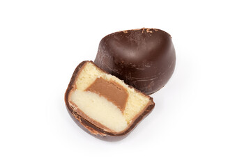 Halved chocolate truffle with marzipan filling on a white background