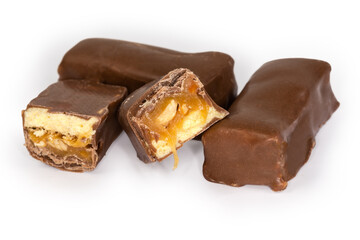 Whole and halved chocolate candies with nougat and nuts filling