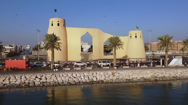 Aerial flying backwards and away from castle shaped building on Tarout Island