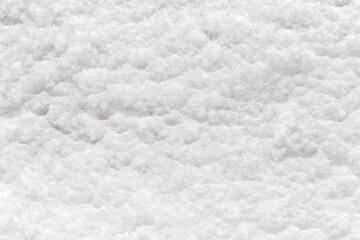 Fototapeta na wymiar Texture of newly-fallen fluffy snow layer on vertical surface