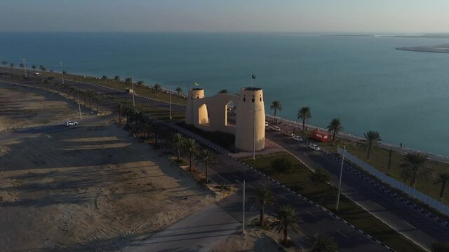 Sunset landscape with castle shaped building on Tarout Island. Aerial circling