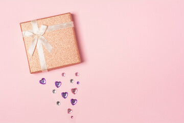 Gift box with hearts on a pink background. Background for the holiday of Valentine's Day. The concept of love, romance and tenderness