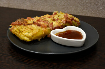 A Potato Gratin on a plate with sauce