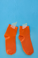 Clean socks drying. Blue background.