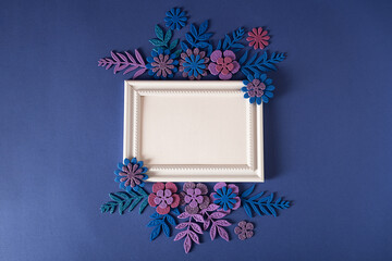 White horizontal frame with handmade flowers on a purple background Cut from paper. Place your text