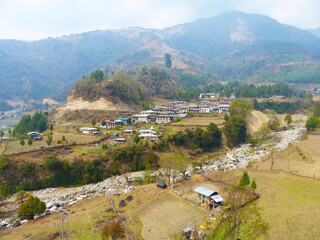Fototapeta na wymiar Hillside village in Bhutan with traditional houses