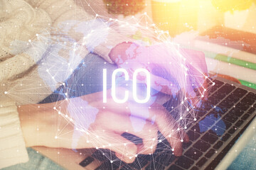 Double exposure of woman hands typing on computer and crypto market theme hologram drawing....