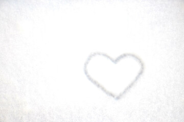 The heart is drawn on fresh snow. The concept of love and romance. Valentine's Day. Winter background