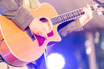 Naklejka premium Cheerful guitarist. Cheerful handsome man playing guitar