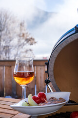grilling salmon on a ceramic grill with charcoal in the garden at a winter day in the outdoor