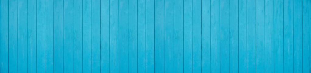 Old weathered wooden plank painted in turquoise blue color. Vintage beach wood background.