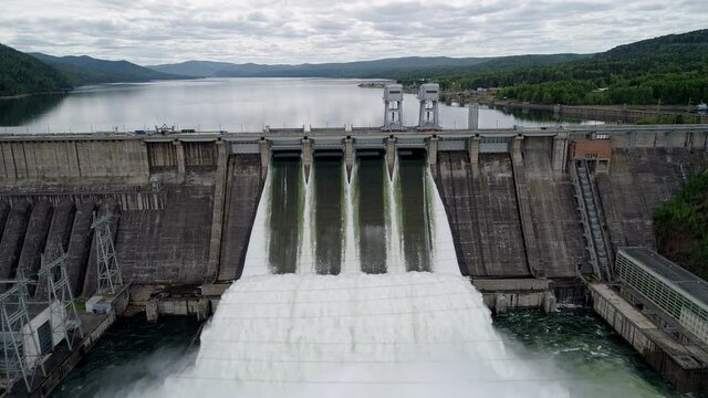 Aerial view of water discharge at hydroelectric power plant of Krasnoyarsk city, Siberia, Russia.