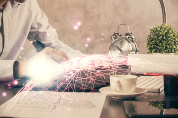 Double exposure of man's hands holding and using a phone and social network theme drawing.