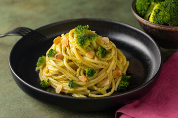 Pasta spaghetti alla chitarra with broccoli sauce and toasted almonds. High angle view.