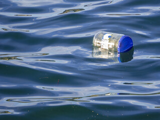Used plastic jar floats on water, plastic waste that harm the environment,water pollution concept.