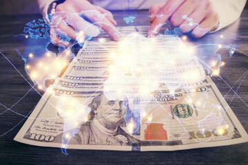 Multi exposure of financial theme drawing hologram and USA dollars bills and man hands. Business concept.