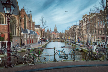 Amsterdam typical buildings with canal and bikes, Netherlands