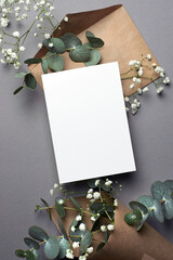 Wedding invitation or greeting card mockup with natural eucalyptus and gypsophila flowers