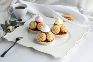 Small tartlet pastries with caramel cream topped with meringue on the table