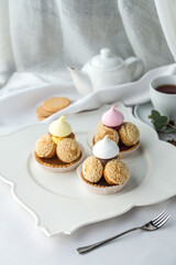 Small tartlet pastries with caramel cream topped with meringue on the table