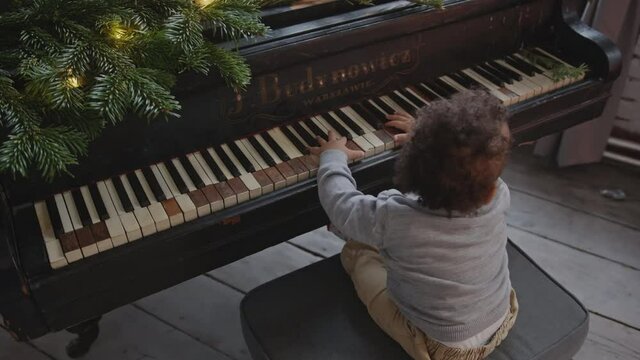 happy child todler playing old piano. High quality 4k footage