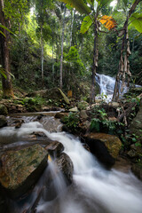 The famous natural waterfall in Maekampong village,Chiangmai province,Thailand.Yellow sign means caution waterfall ahead in thai language.Attractive place for traveller.