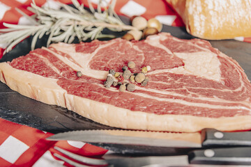 Variety of Raw Black Angus Prime meat steaks Machete, Blade on bone, Striploin, Rib eye, Tenderloin fillet mignon on wooden board.