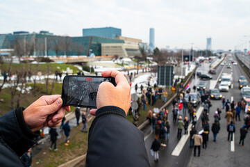 filming  with mobile phone protesters blocking the highway