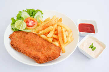 Fish schnitzel with fries isolated on white background.