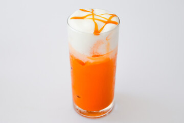 Glass Thai Iced tea with milk on white background.