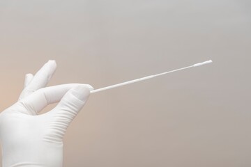 Hand holding quick flu test swab