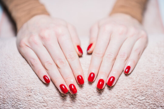 Close up image of woman hands with red  painted fingernails. Manicure concept ,focus on nails.