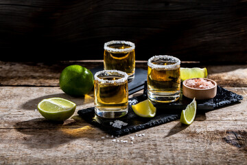 Mexican tequila with lime and salt on rustic black background. space for text. luxury drink. Alcoholic drink concept