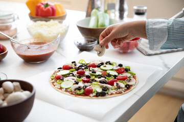 Adding Ingredients To Home Made Pizza